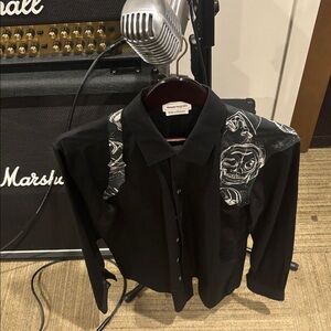 Alexander Mcqueen mens black with skull print gun holster styled shirt.
